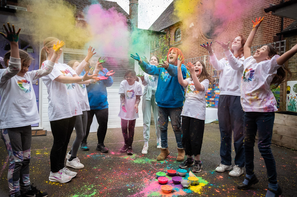 Arts for life group playing with holi