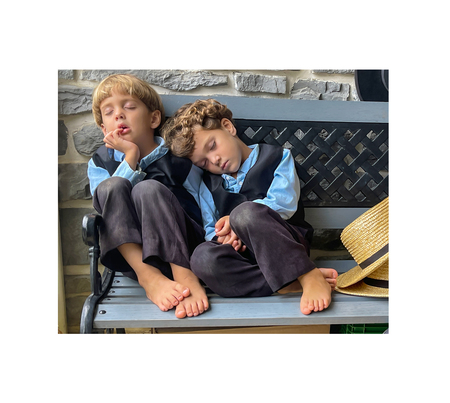 Four year old twin boys catching a nap on their grandparents porch.